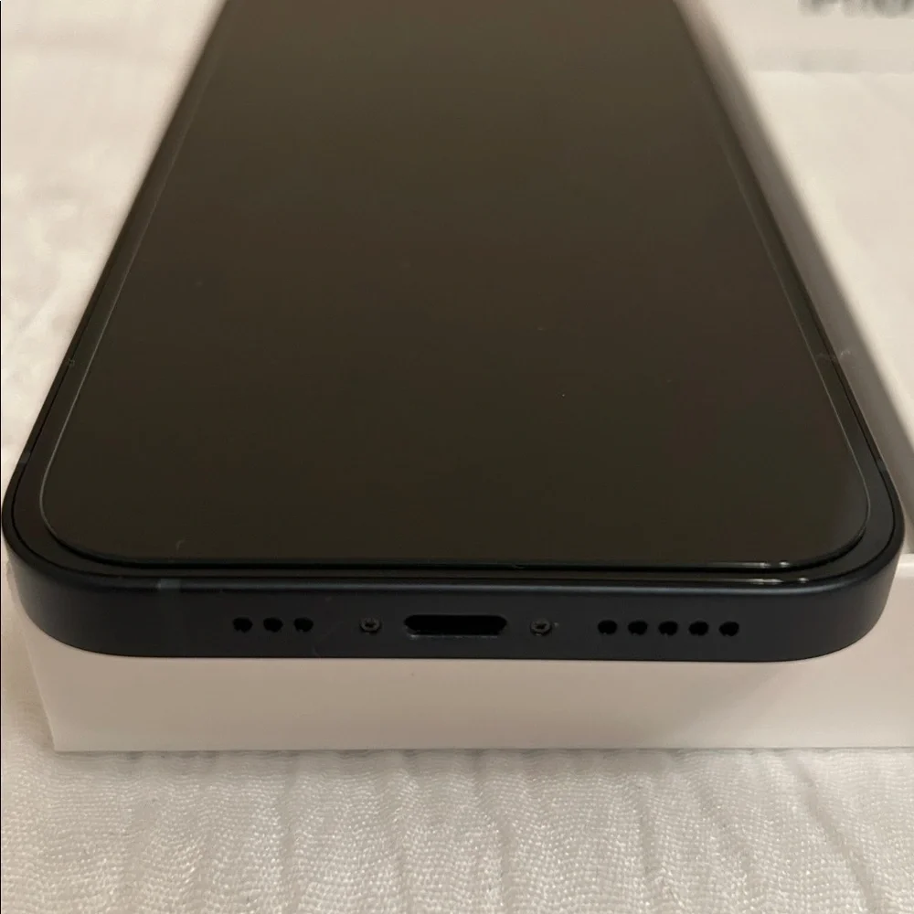 Apple iPhone with Black Screen and White Packaging
